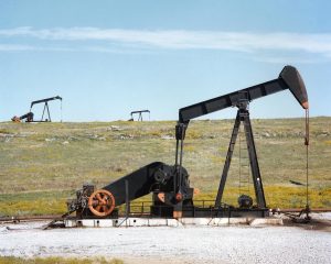 Oil pump jacks in a field for oil and gas exploration